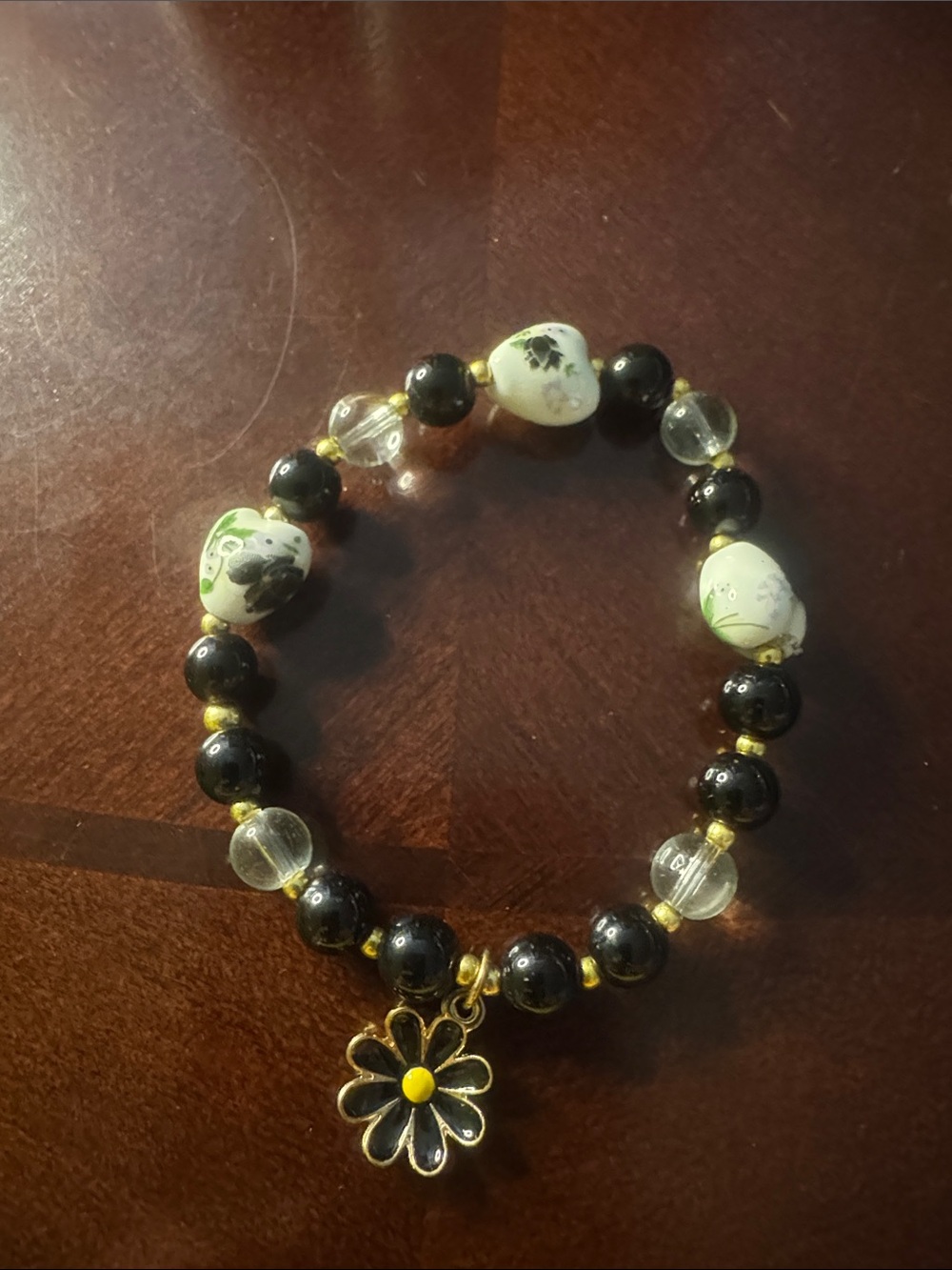 Black, gold, clear, white/floral bracelet